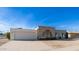 Mid-century modern home with a white garage door and brick facade at 14202 N Lakeforest Dr, Sun City, AZ 85351