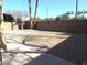 Small backyard with gravel, a small lawn, and tall trees at 1435 S Spartan St, Gilbert, AZ 85233