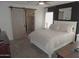 Main bedroom with barn door, ceiling fan, and en-suite bathroom at 1435 S Spartan St, Gilbert, AZ 85233