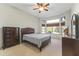 Spacious bedroom with large windows and ceiling fan at 14408 W Corral Dr, Sun City West, AZ 85375