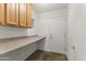 Laundry room with built-in cabinets and counter space at 14408 W Corral Dr, Sun City West, AZ 85375