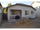 Small backyard with patio and grill, featuring a small table and chairs at 15466 W Laurel Ln, Surprise, AZ 85379