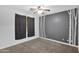 Bedroom with gray walls, dark curtains, and carpet at 15466 W Laurel Ln, Surprise, AZ 85379