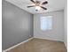 Spacious bedroom with ceiling fan and neutral wall colors at 15466 W Laurel Ln, Surprise, AZ 85379