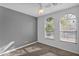 Bright bedroom featuring arched windows and ceiling fan at 15466 W Laurel Ln, Surprise, AZ 85379