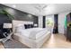 Main bedroom with a beige upholstered bed and dark gray accent wall at 1638 E Hackamore St, Mesa, AZ 85203