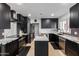 Modern kitchen with black cabinetry, white quartz countertops and island at 1638 E Hackamore St, Mesa, AZ 85203