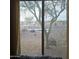 View of the backyard from inside the home, showing desert landscaping at 16464 W Piccadilly Rd, Goodyear, AZ 85395