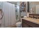 Clean bathroom with a shower/tub combo and updated vanity at 16464 W Piccadilly Rd, Goodyear, AZ 85395