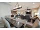 Open concept dining area with a large wooden table and chandelier at 16464 W Piccadilly Rd, Goodyear, AZ 85395