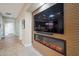 Bright entryway with modern fireplace and wood wall accents at 16464 W Piccadilly Rd, Goodyear, AZ 85395