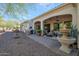 Home exterior with a covered patio and fountain at 16464 W Piccadilly Rd, Goodyear, AZ 85395