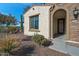 Front entry of home with decorative door and landscaping at 16464 W Piccadilly Rd, Goodyear, AZ 85395