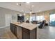 Spacious kitchen with an island, stainless steel appliances, and granite countertops at 16464 W Piccadilly Rd, Goodyear, AZ 85395