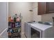 Convenient laundry room with washer, dryer, and storage shelves at 16464 W Piccadilly Rd, Goodyear, AZ 85395