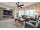 Living room with fireplace and large windows, offering natural light at 16464 W Piccadilly Rd, Goodyear, AZ 85395