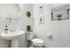 Clean bathroom with pedestal sink, toilet and decorative accents at 1705 S 82Nd Pl, Mesa, AZ 85209