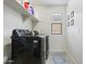 Convenient laundry room with washer, dryer, and ample shelving at 1705 S 82Nd Pl, Mesa, AZ 85209