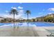 Community pool with palm trees and lounge chairs at 1705 S 82Nd Pl, Mesa, AZ 85209