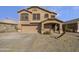 Two story house with tan exterior, double garage, and landscaped front yard at 1708 E Galveston St, Gilbert, AZ 85295