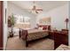 Bedroom with wood sleigh bed and ceiling fan at 1740 W Del Rio St, Chandler, AZ 85224