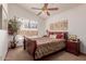 Bedroom with wood sleigh bed and ceiling fan at 1740 W Del Rio St, Chandler, AZ 85224