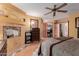 Main bedroom with fireplace, walk-in closet, and ceiling fan at 1740 W Del Rio St, Chandler, AZ 85224