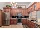 Kitchen with dark wood cabinets, granite countertops, and stainless steel appliances at 1740 W Del Rio St, Chandler, AZ 85224