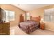 Bright bedroom with a wooden bed frame and neutral color scheme at 18109 W Skyline Dr, Surprise, AZ 85374