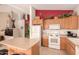 Kitchen boasts wood cabinets, ample counter space, and white appliances at 18109 W Skyline Dr, Surprise, AZ 85374