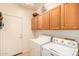 Laundry room with washer, dryer, and ample cabinet storage at 18109 W Skyline Dr, Surprise, AZ 85374