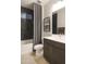 Clean bathroom with dark tile and a modern vanity at 19021 W Rose Ln, Waddell, AZ 85355