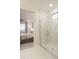 Modern bathroom with a walk-in shower and marble tile at 19021 W Rose Ln, Waddell, AZ 85355