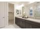 Double vanity bathroom with marble floors and walk-in shower at 19021 W Rose Ln, Waddell, AZ 85355