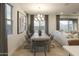 Elegant dining room featuring a large wood table and modern light fixture at 19021 W Rose Ln, Waddell, AZ 85355