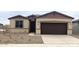 Single-story home with brown garage door and landscaping at 19021 W Rose Ln, Waddell, AZ 85355