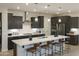 Modern kitchen with dark cabinets and island at 19021 W Rose Ln, Waddell, AZ 85355