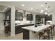 Spacious kitchen featuring dark cabinetry, white quartz countertops, and stainless steel appliances at 19021 W Rose Ln, Waddell, AZ 85355