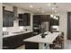 Modern kitchen with dark cabinets and island at 19021 W Rose Ln, Waddell, AZ 85355