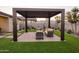 Pergola and seating area in a landscaped backyard at 19027 W Rose Ln, Waddell, AZ 85355