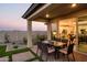 Patio with table and chairs, view of kitchen through sliding doors at 19027 W Rose Ln, Waddell, AZ 85355