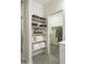 Well-organized linen closet with shelves and hanging space at 19027 W Rose Ln, Waddell, AZ 85355