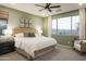 Bright bedroom with large window, plush bed, and stylish decor at 19027 W Rose Ln, Waddell, AZ 85355