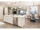 Open concept kitchen with island and adjacent dining area at 19027 W Rose Ln, Waddell, AZ 85355