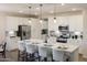 Modern kitchen with white cabinets, large island, and stainless steel appliances at 19027 W Rose Ln, Waddell, AZ 85355