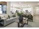 Comfortable living room with green velvet armchairs and neutral sofa at 19027 W Rose Ln, Waddell, AZ 85355