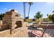 Stone fireplace with seating area and pool view at 19035 E Tonto Trl, Rio Verde, AZ 85263