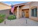 Welcoming entryway with a wooden door and nicely landscaped area at 19035 E Tonto Trl, Rio Verde, AZ 85263