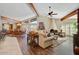 Open and airy living room with hardwood floors, a fireplace, and adjacent dining area at 19035 E Tonto Trl, Rio Verde, AZ 85263