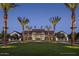 Elegant community clubhouse with palm trees and nighttime lighting at 1928 W Rowel Rd, Phoenix, AZ 85085